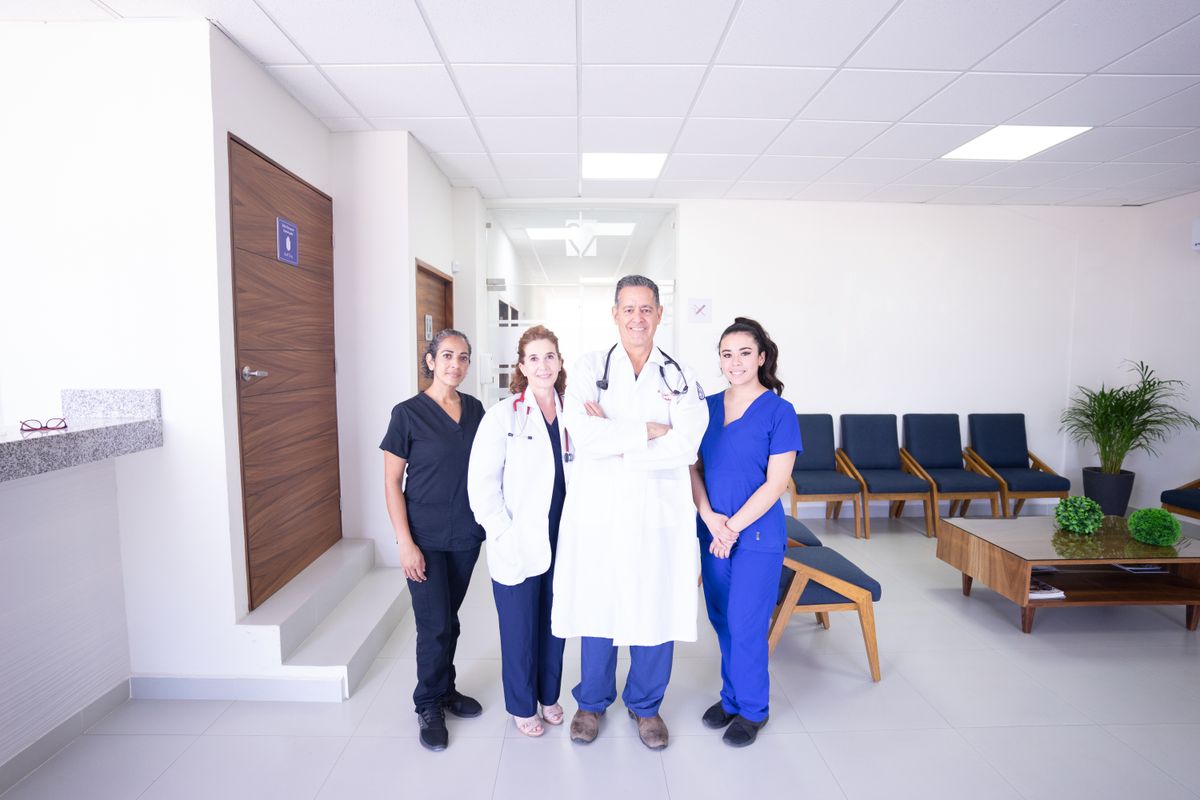 Dental practice team standing together in a bright clinic reception